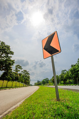 Traffic sign turn left curve and road in the forest