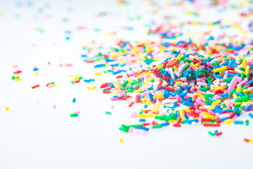Colorful candy sprinkles close up for birthday cake on white background