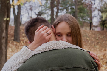 Fototapeta premium Happy young couple walking on a autumn day in the park.They are having fun together. cute teenager