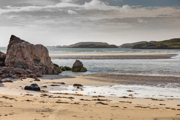 Fototapeta na wymiar sandy beach with dune grass in Scotland, Isle of Lewis at low tide