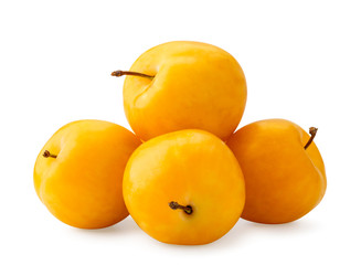 Pile of yellow plums closeup on a white. Isolated.