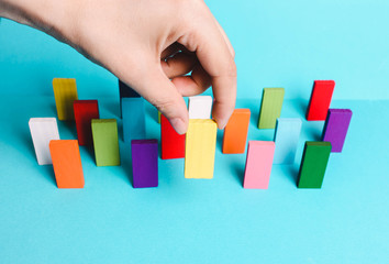 Colored dominoes stand on a blue background.Concept creative, logical thinking, art,Creativity inspiration