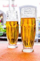 Two glasses of fresh beer on the table