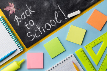 Colorful School stationery and chalkboard on colorful background