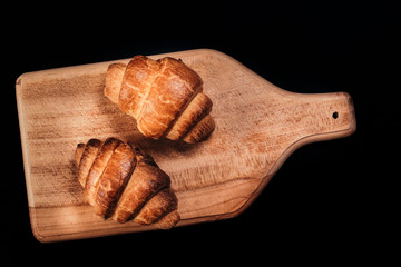 two tasty crispy French croissant.dark background.top view.