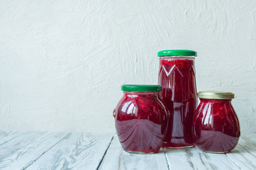 Three jars of jam on a white table