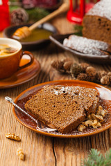Homemade gingerbread cake. Christmas decoration. Front view. Natural wooden background.