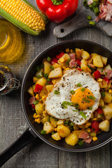 Traditional American hash with fried eggs. Top view.