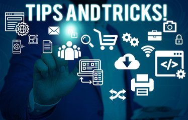 Conceptual hand writing showing Tips And Tricks. Concept meaning means piece advice maybe suggestion how improve Male human wear formal suit presenting using smart device