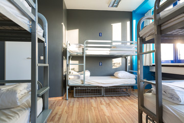 Hostel interior, metal bunk beds and linen, nobody - obrazy, fototapety, plakaty