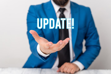Text sign showing UPDATE. Business photo text make something more modern or up to date like software program Man holds empty paper with copy space in front of him Copy Space