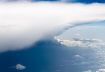 Blue sky and silky white clouds with impressive shapes, views over the heights
