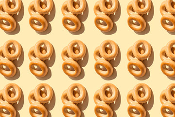 Bagels pattern on a peach color background . Bakery product template, traditional Russian bread product. Creative layout. Top view