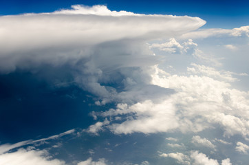 Blue sky and silky white clouds with impressive shapes, views over the heights