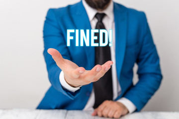 Text sign showing Fined. Business photo text clarify beer by causing precipitation of sediment during production Man holds empty paper with copy space in front of him Copy Space