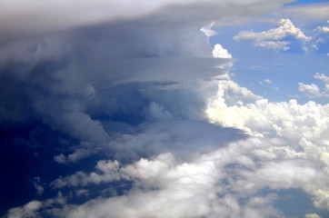 Blue sky and silky white clouds with impressive shapes, views over the heights