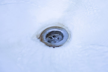 close up water pours throught the wash sink