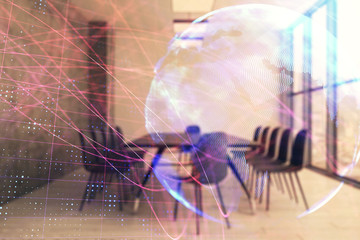 Double exposure of globe hologram on conference room background. Concept of international business