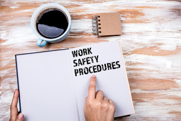 Work Safety and Safety Procedures concept. Hands holding book on office table
