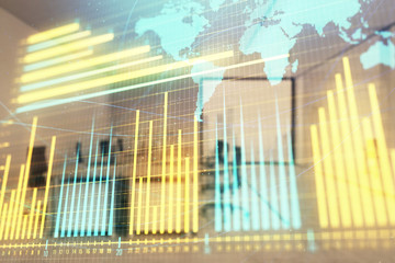 Stock and bond market graph and world map with trading desk bank office interior on background. Multi exposure. Concept of international finance
