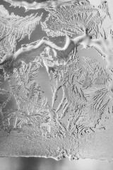 Frosty pattern at a winter window glass macro with selective focus