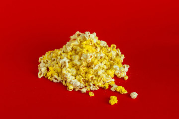 a bunch of popcorn dropped on the color surface flat lay