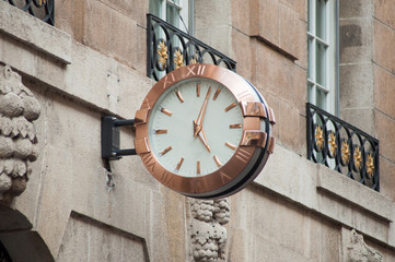 Fototapeta na wymiar closeup of vintage clock in the street