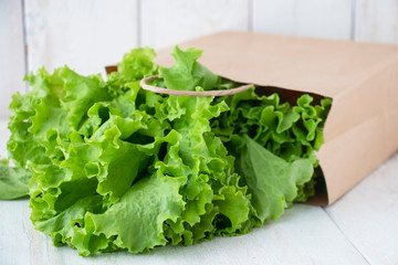 fresh green salad in beige paper ecological packaging