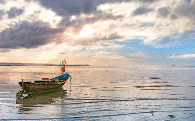 beautiful calmness seascape with small fishing boat and cloudy sky