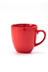 red ceramic mug on white background