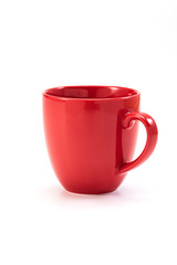 red ceramic mug on white background