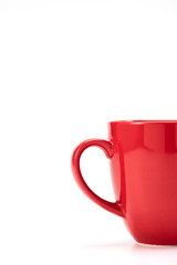 red ceramic mug on white background