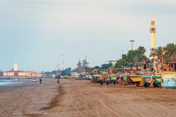 05/11/2019 Bandar Abbas, Hormozgan Province, Iran, many colorful fishing boats on the Persian Gulf coast stand at dawn and wait for the beginning of the working day.