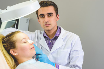 The doctor prepares the patient for surgery.