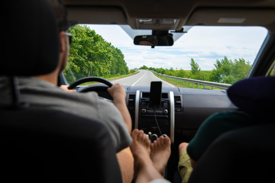 Woman Sitting At Backseats Of Car Put Legs On Armrest Sunroof