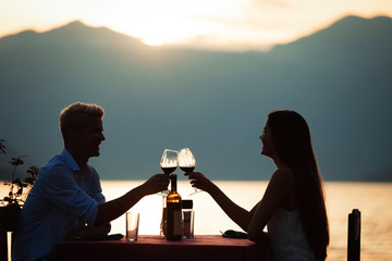 Couple is having a private event dinner on a tropical beach during sunset time