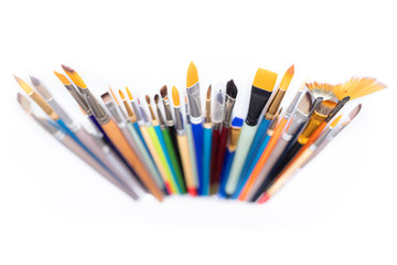 Fototapeta premium Colorful cosmetic brushes close up on white background