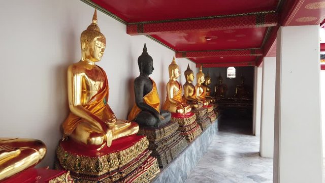 4K Row of golden buddha statues at Wat Pho
