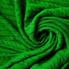 Fototapeta na wymiar Texture of knitted green fabric. Crocheted abstract background.