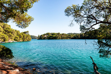 A great view to a small isle at mljet framed with trees