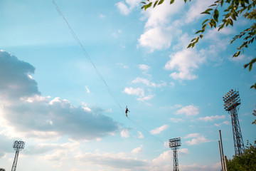 Highliner on the background of blue sky.