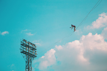 Highliner on the background of blue sky.