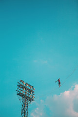 Highliner on the background of blue sky.