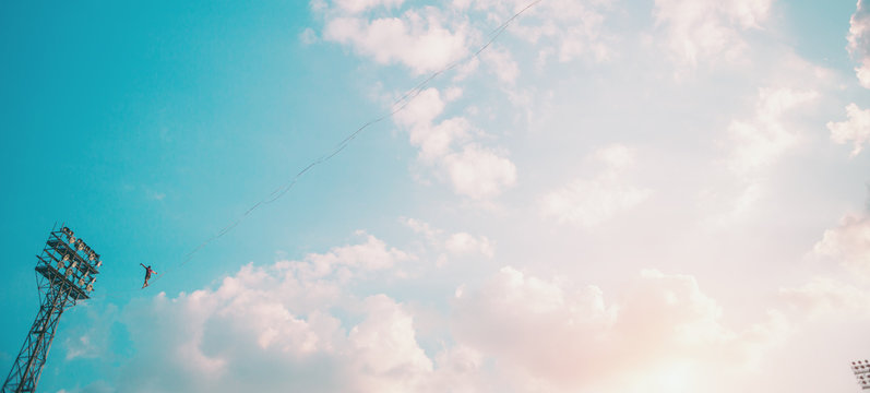 Highliner on the background of blue sky.