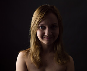 portrait of young woman, no make up, low key, brown dark hair, natural looking making expressions 