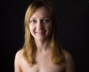 Fototapeta premium portrait of young woman, no make up, low key, brown dark hair, natural looking making expressions 