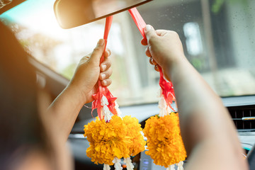 Woman flower garland in hand and praying in the new car for lucky, safety in Thai style © SKT Studio
