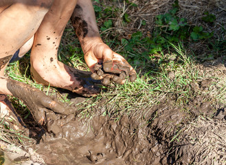Boy working and playing in the mud
