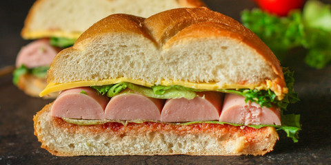 burger with sausages, cheese, lettuce, tomato sauce (snack sandwich, bun). top food background. copy space