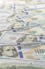 Background from chaotically lying of notes for one hundred dollars.